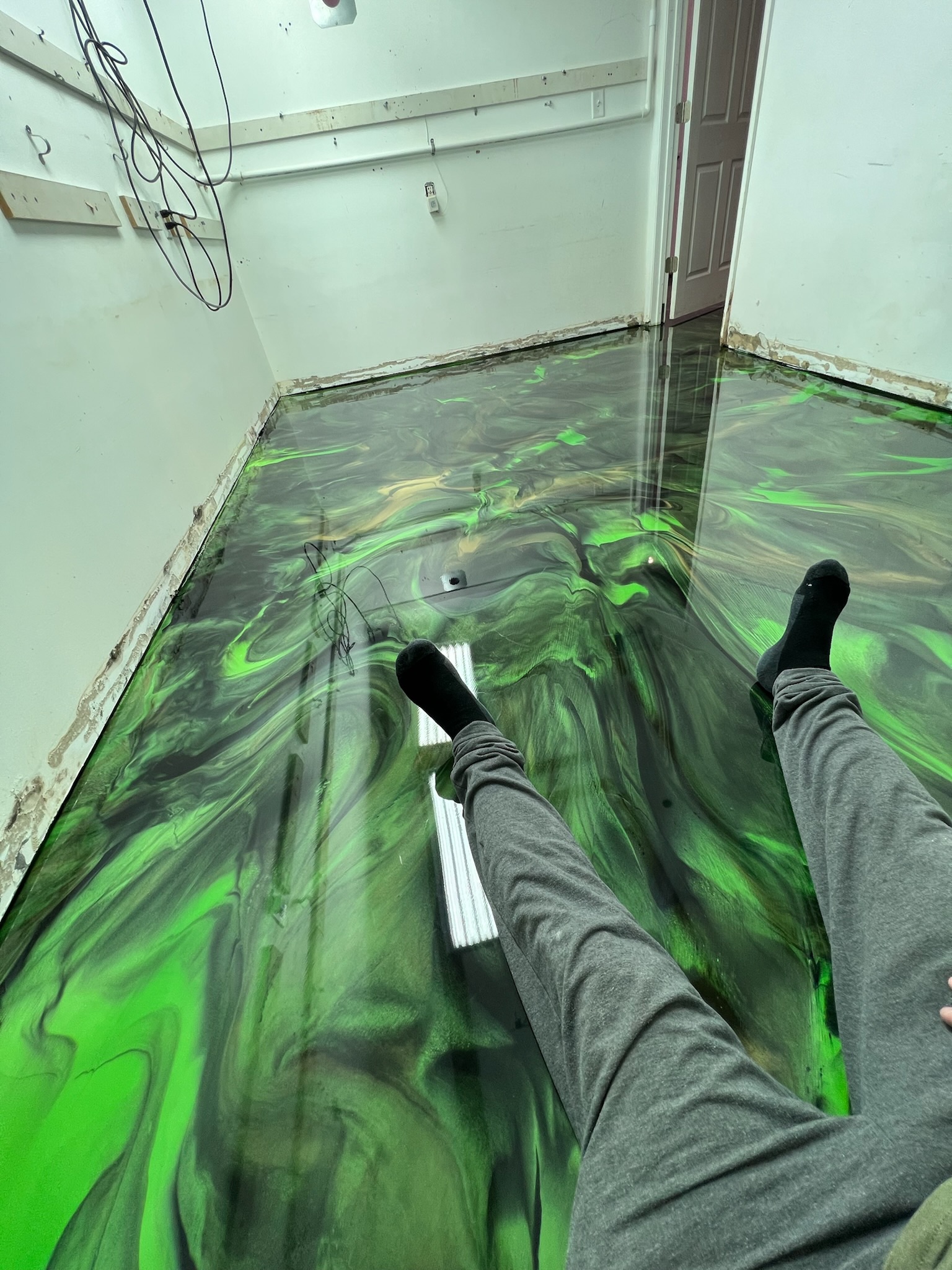 Green and black marbled metallic epoxy floor in Gilbert, AZ