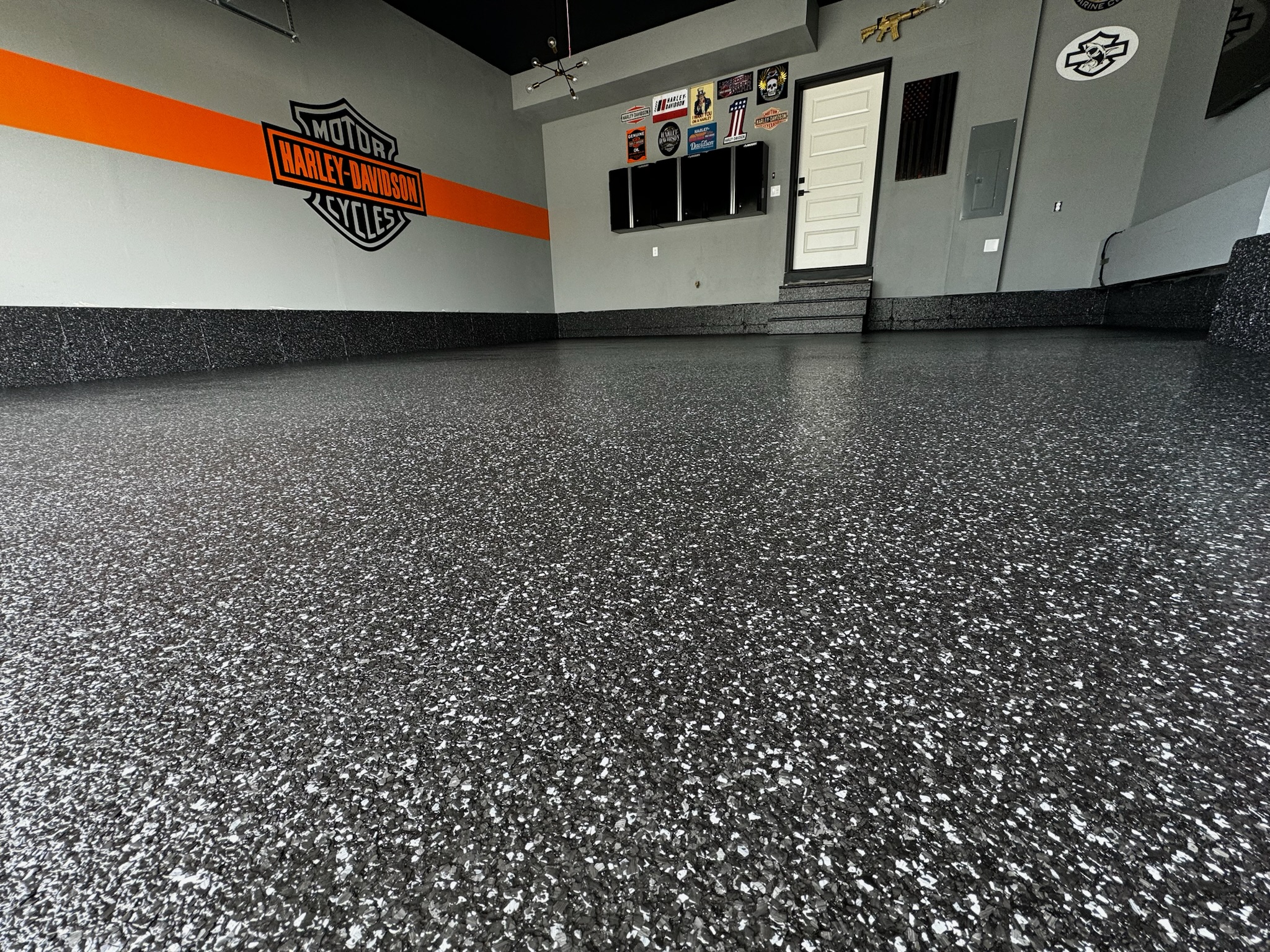 Black and gray flake floor in a garage with a Harley-Davidson wall graphic in Gilbert, AZ