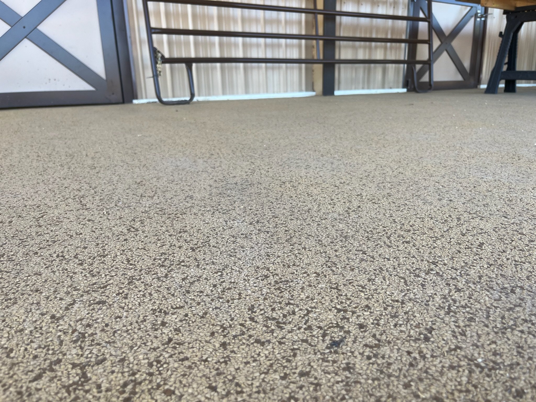 Gray flake floor in a garage with barn-style doors and built-in cabinets in Gilbert, AZ